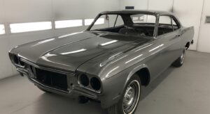 Classic car with gloss finish paint job in restoration shop
